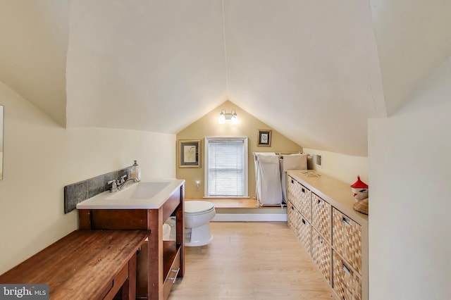 7017 Woodland Ave, Takoma Park, MD 20912 - bathroom featuring wood finished floors, toilet, lofted ceiling, and vanity