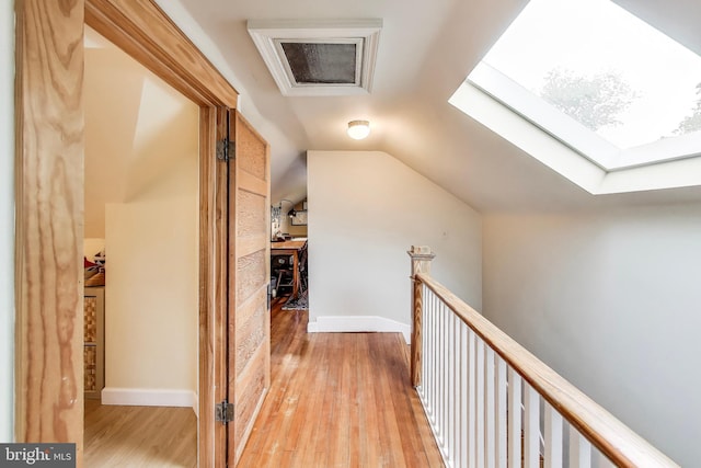 7017 Woodland Ave, Takoma Park, MD 20912 - corridor featuring light wood-type flooring, a skylight, an upstairs landing, and vaulted ceiling