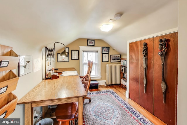 7017 Woodland Ave, Takoma Park, MD 20912 - dining space with radiator, wood finished floors, lofted ceiling, and a desk