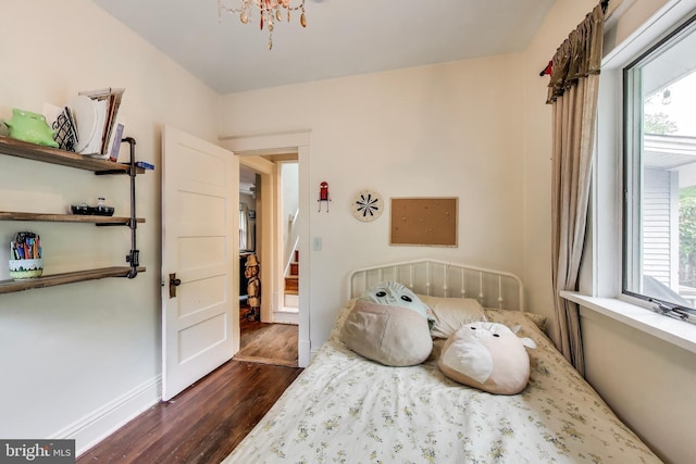 7017 Woodland Ave, Takoma Park, MD 20912 - bedroom featuring dark wood-style flooring, a chandelier, and baseboards