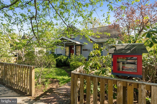 7017 Woodland Ave, Takoma Park, MD 20912 - view of front facade featuring fence and a shingled roof