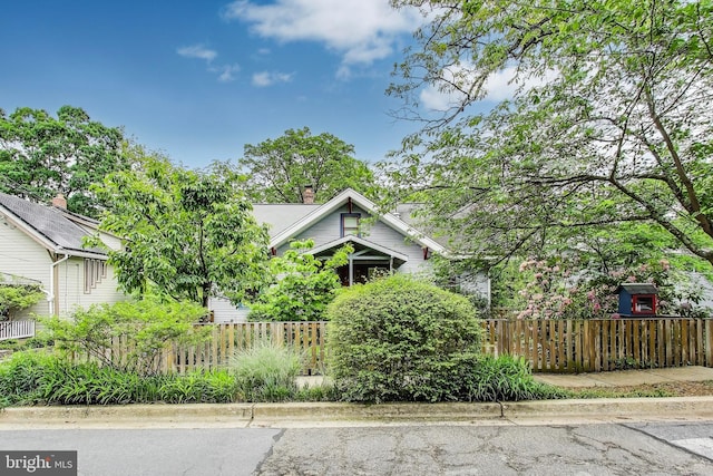 7017 Woodland Ave, Takoma Park, MD 20912 - view of side of property featuring a fenced front yard and a chimney