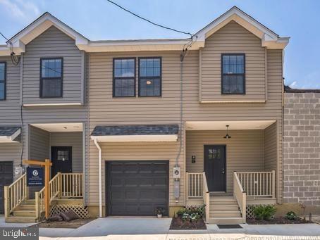504 Richey Ave, Collingswood, NJ 08107 - townhome / multi-family property with a garage, concrete driveway, and a porch