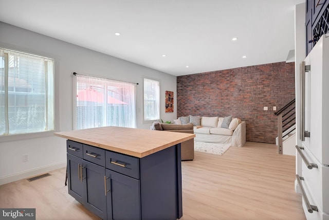 504 Richey Ave, Collingswood, NJ 08107 - kitchen with butcher block countertops, light wood finished floors, recessed lighting, an accent wall, and brick wall