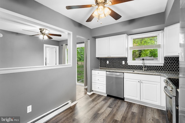 kitchen featuring stainless steel appliances, a sink, baseboard heating, and ceiling fan