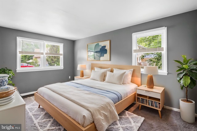 bedroom featuring baseboards and carpet