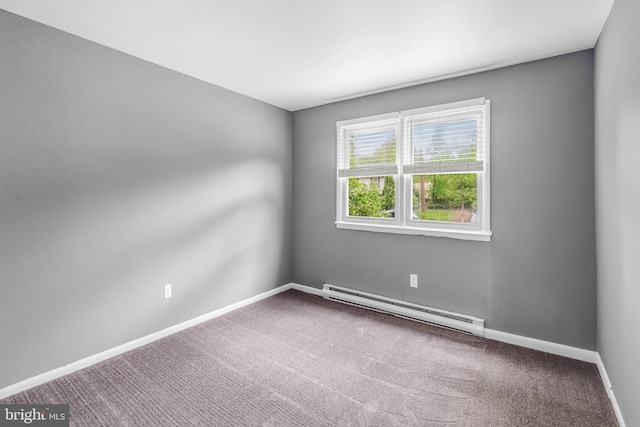 carpeted spare room featuring a baseboard radiator and baseboards