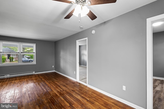 unfurnished bedroom with wood finished floors, a baseboard heating unit, baseboards, and a ceiling fan