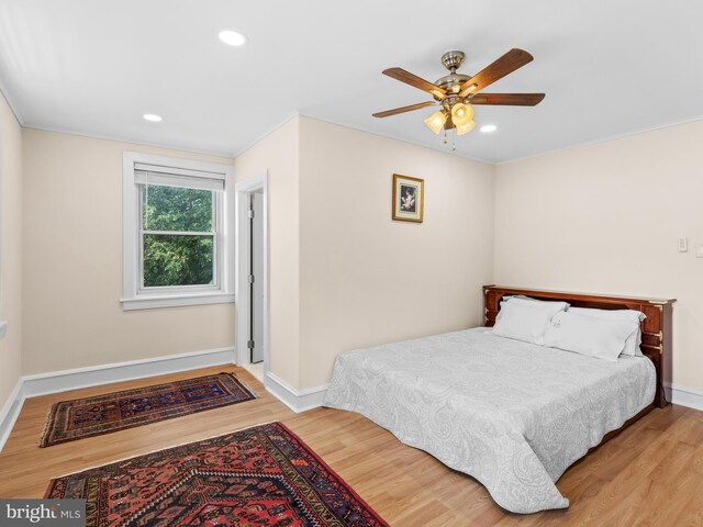 bedroom with wood finished floors, baseboards, recessed lighting, and a ceiling fan