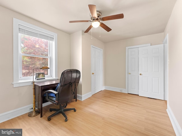 office space featuring wood finished floors, baseboards, and a ceiling fan