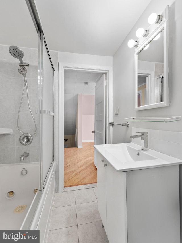 full bath with vanity, tile patterned floors, and bath / shower combo with glass door
