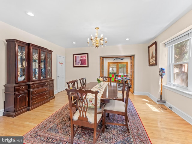 dining area with light wood finished floors, a chandelier, baseboards, and recessed lighting