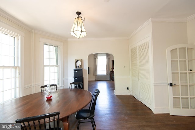 116 Oakley St, Cambridge, MD 21613 - dining space featuring arched walkways, dark wood finished floors, and crown molding