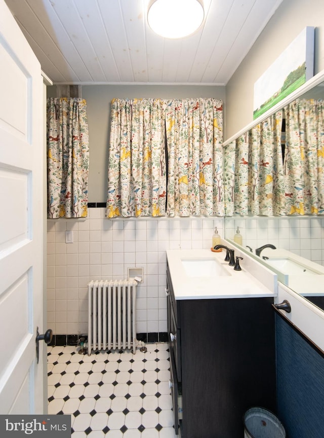 116 Oakley St, Cambridge, MD 21613 - bathroom featuring radiator heating unit, vanity, tile walls, wooden ceiling, and wainscoting