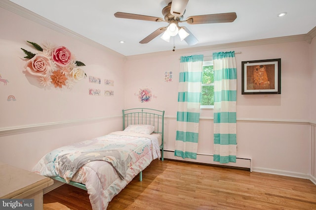 bedroom featuring a baseboard heating unit, wood finished floors, crown molding, recessed lighting, and ceiling fan