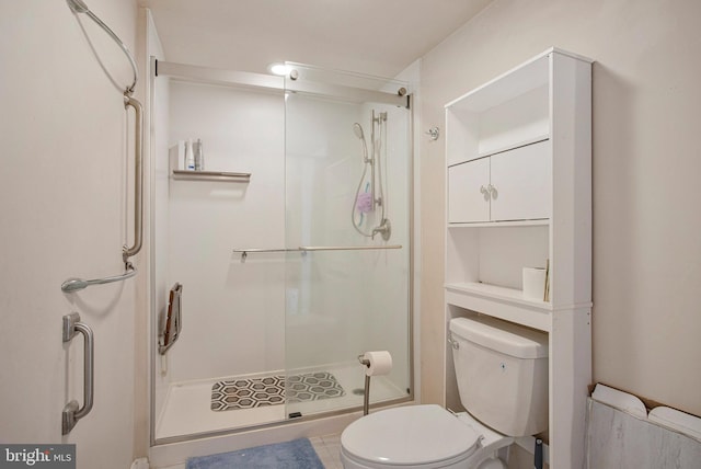 bathroom featuring a shower stall and toilet