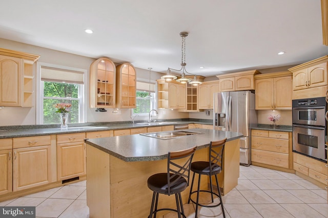 kitchen featuring stainless steel appliances, light brown cabinets, open shelves, glass insert cabinets, and light tile patterned floors