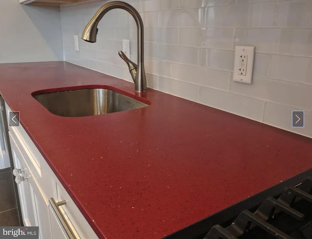 137 S 49th St, Philadelphia, PA 19139 - kitchen view of a sink, backsplash, and white cabinets