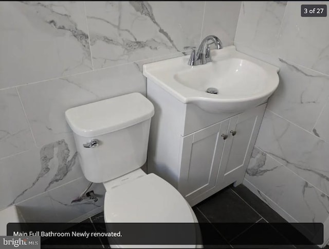 137 S 49th St, Philadelphia, PA 19139 - bathroom featuring tile walls, vanity, and toilet