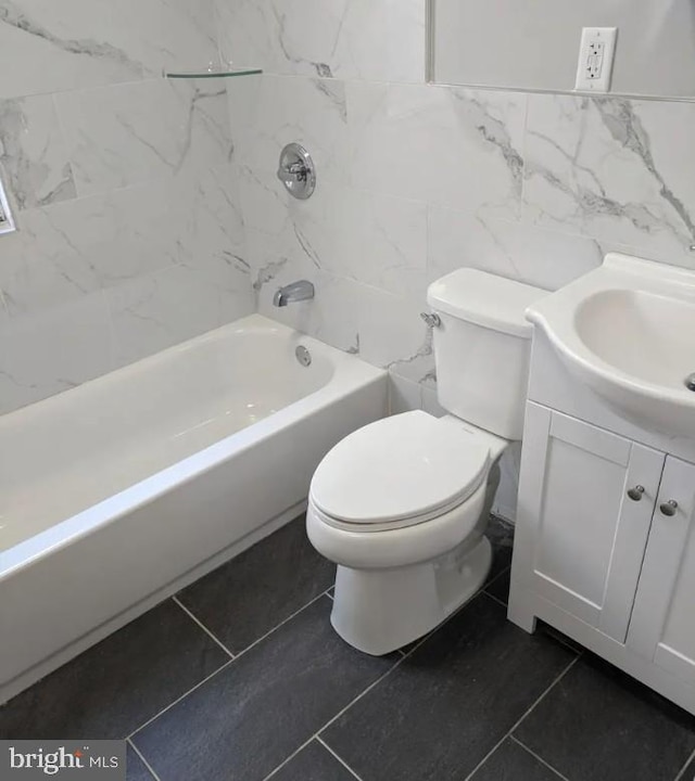 137 S 49th St, Philadelphia, PA 19139 - full bath featuring tile walls, tile patterned flooring, toilet, vanity, and shower / bathtub combination