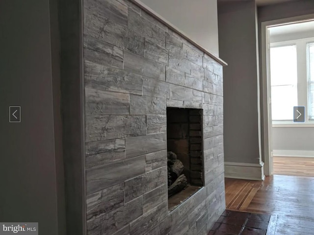 137 S 49th St, Philadelphia, PA 19139 - detailed view of wood finished floors, baseboards, and a fireplace with flush hearth