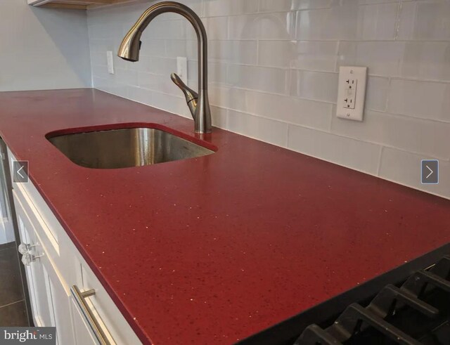 137 S 49th St, Philadelphia, PA 19139 - kitchen view of a sink, backsplash, and white cabinets