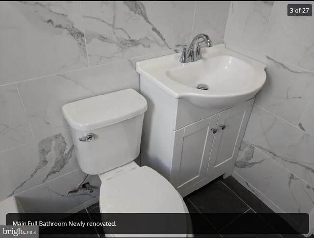 137 S 49th St, Philadelphia, PA 19139 - bathroom featuring tile walls, vanity, and toilet