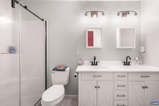 full bath featuring a sink, double vanity, toilet, and a stall shower