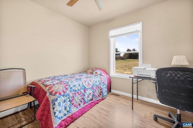 bedroom with baseboards, a ceiling fan, and wood finished floors