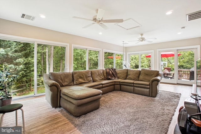 living area featuring a ceiling fan, plenty of natural light, wood finished floors, and recessed lighting