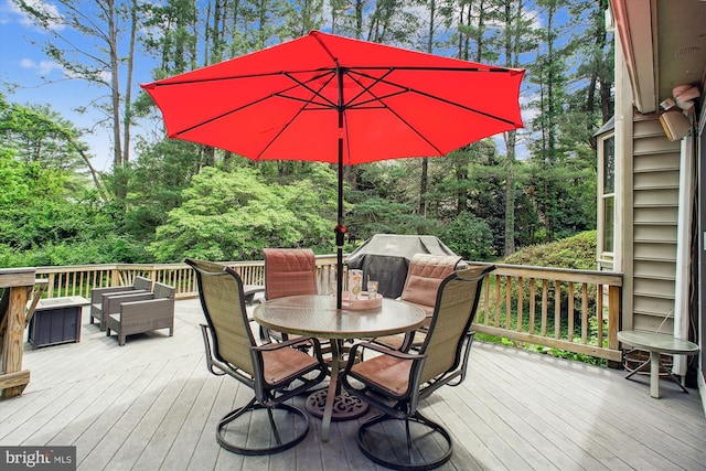 wooden deck featuring outdoor dining area