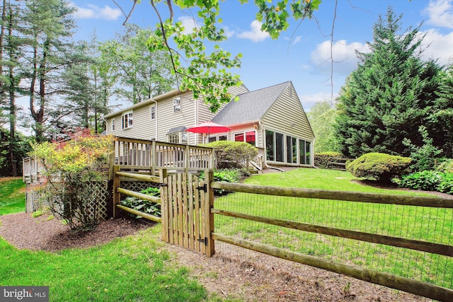 back of house featuring a gate and a deck