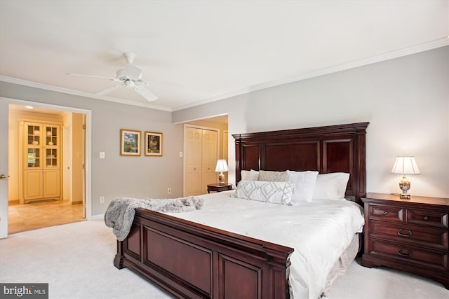 bedroom with crown molding, light carpet, a closet, ceiling fan, and baseboards