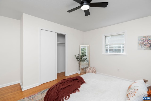 bedroom with baseboards, a closet, a ceiling fan, and wood finished floors