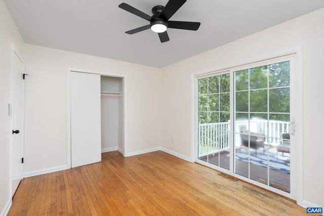 unfurnished bedroom featuring a closet, visible vents, light wood finished floors, baseboards, and access to exterior