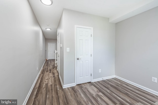 2108 E Hoffman St, Baltimore, MD 21213 - corridor with dark wood-style flooring and baseboards