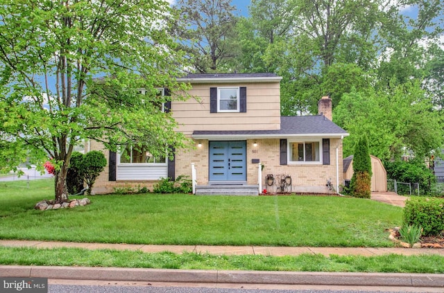view of front of home with brick siding, a front yard, and a chimney
