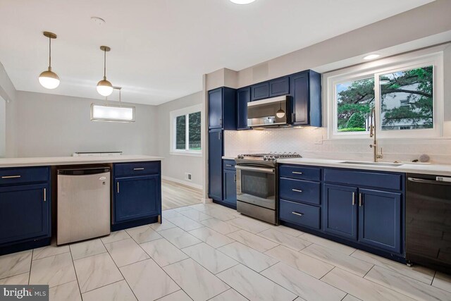 kitchen featuring stainless steel appliances, blue cabinetry, and a sink