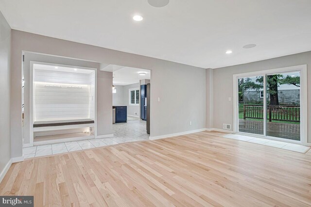 unfurnished living room featuring light wood finished floors, baseboards, and recessed lighting