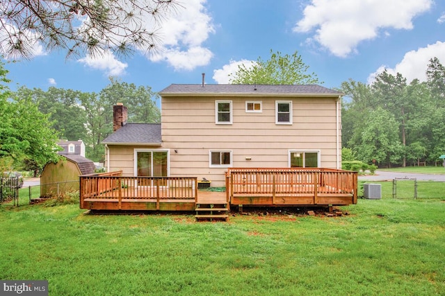 rear view of house featuring a chimney, central air condition unit, and a wooden deck