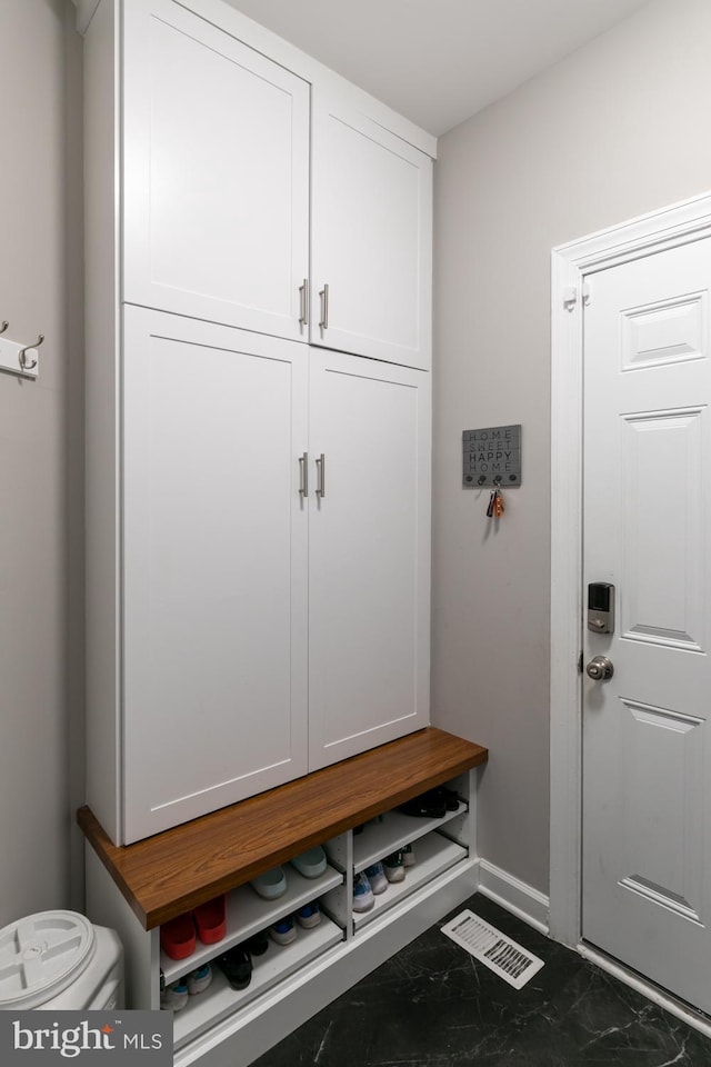 10609 Little Run Farm Ct, Vienna, VA 22182 - mudroom featuring marble look tiles and baseboards