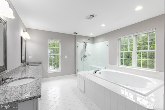 10609 Little Run Farm Ct, Vienna, VA 22182 - bathroom with a tub with jets, a shower stall, double vanity, tile patterned flooring, and recessed lighting