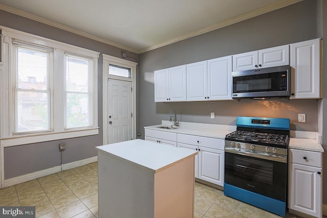 2014 Penrose Ave, Baltimore, MD 21223 - kitchen featuring appliances with stainless steel finishes, a sink, light countertops, white cabinetry, and crown molding