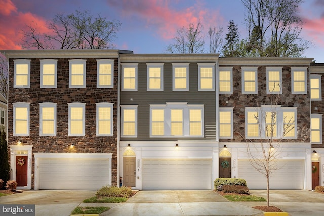 multi unit property with a garage and driveway