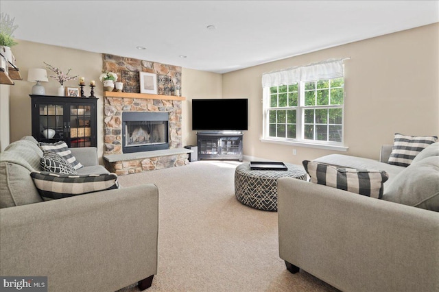carpeted living room with a fireplace