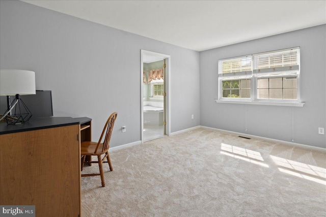 carpeted office space with baseboards