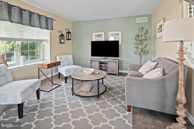 living area featuring wood finished floors and baseboards