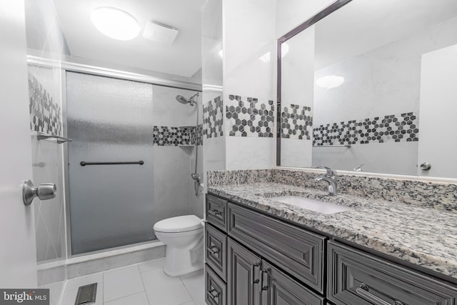full bathroom featuring a shower stall, toilet, tile patterned floors, and vanity