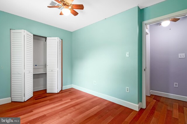 unfurnished bedroom with light wood-style floors, baseboards, a closet, and ceiling fan