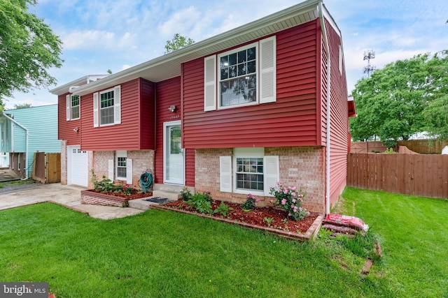 bi-level home featuring brick siding, a garage, and driveway